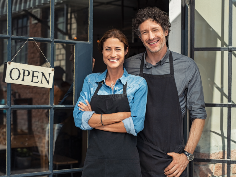 Franchise Business Owners Standing in Front of Store